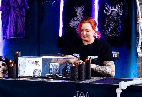 Eine Mitarbeiterin im Verkauf bei einem Pop-Up-Store der Band Ghost